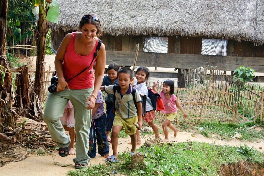 walking through the hills of vietnam with children following