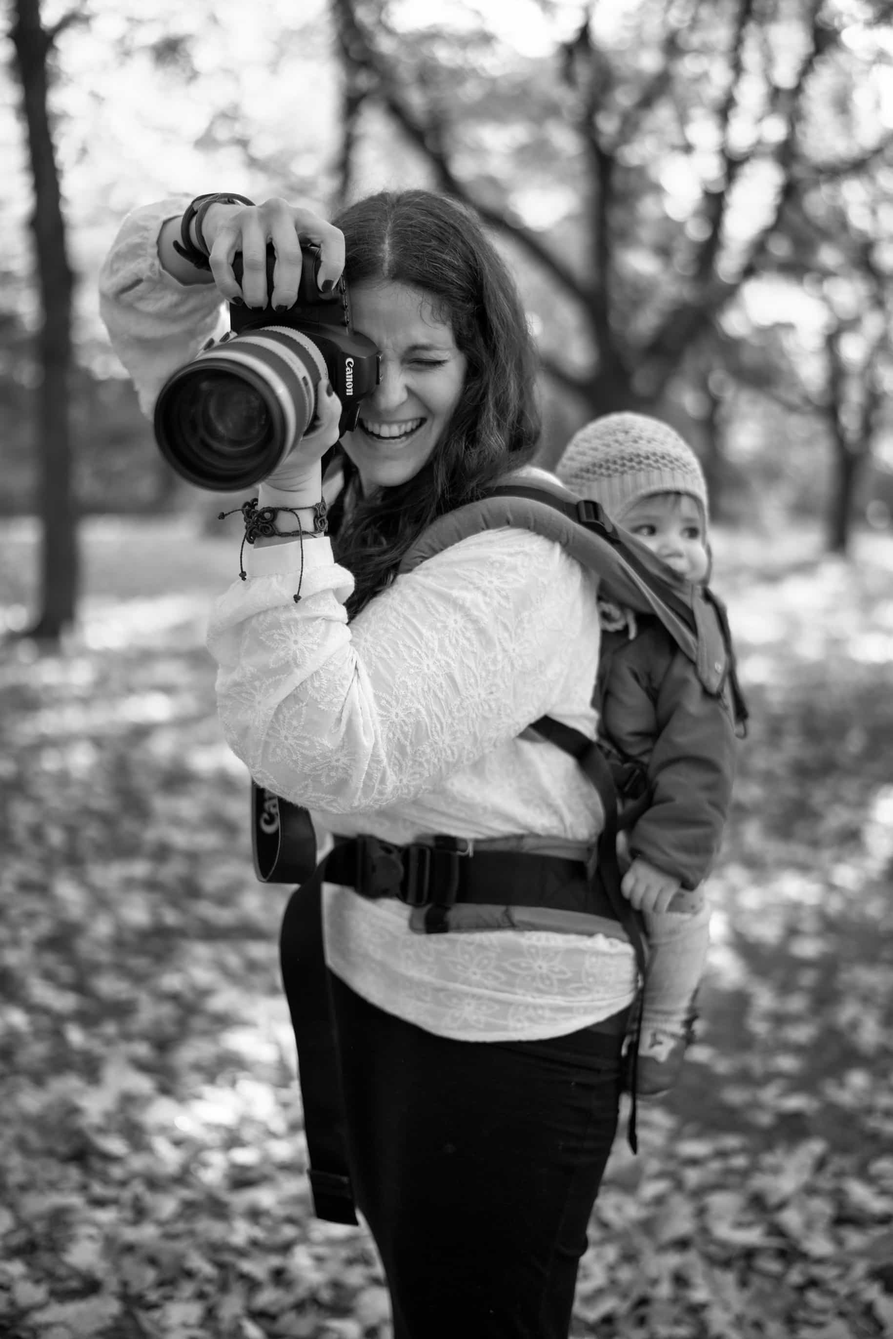 photographer taking a picture while babywearing