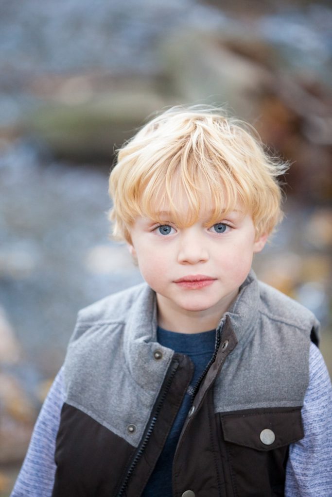 a boy dressed in a vest during his fall family session