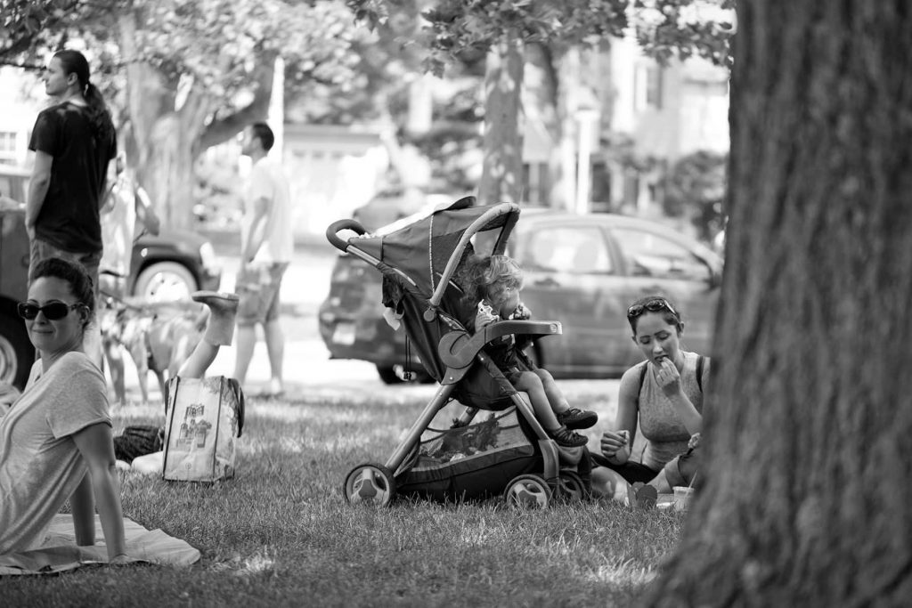 families picnic on the lawn outside of the market