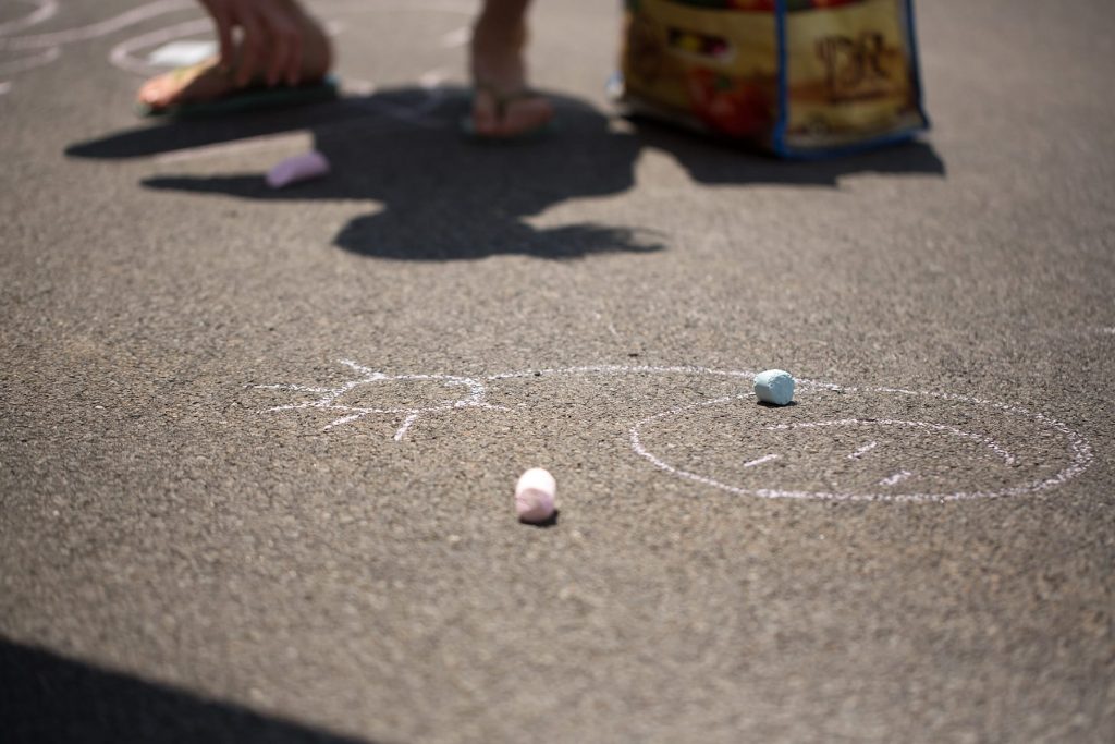 children draw with sidewalk chalk