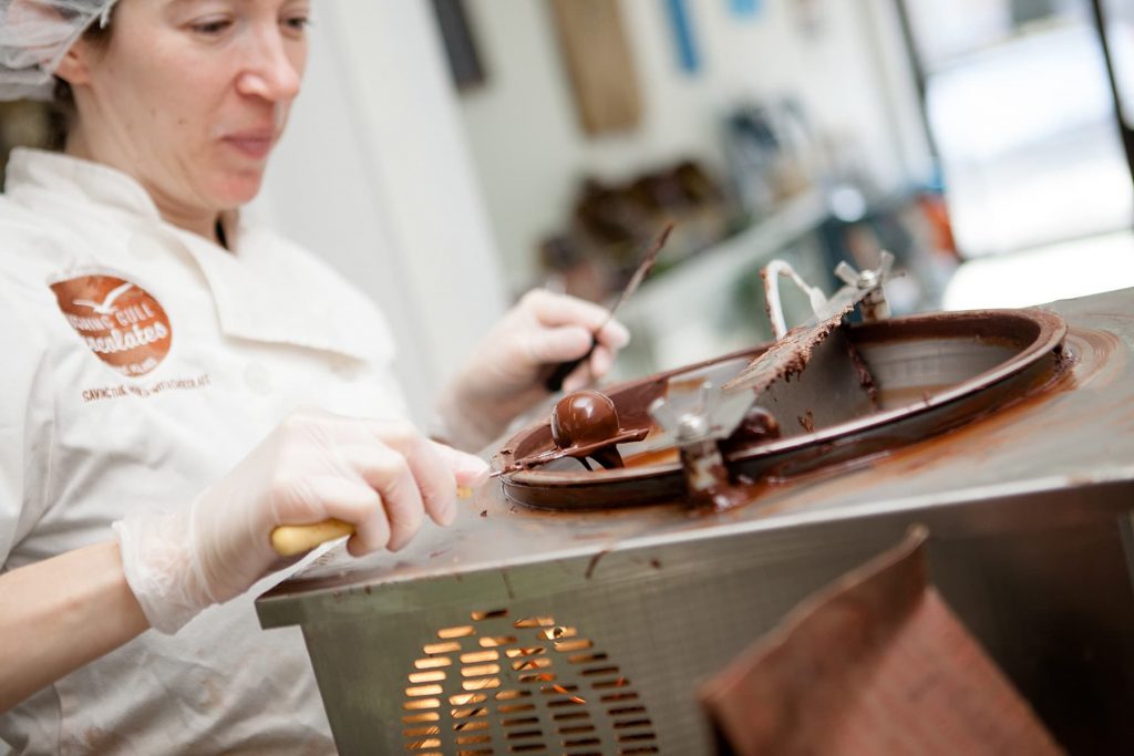 A woman working in her chocolate store in Rochester, NY
