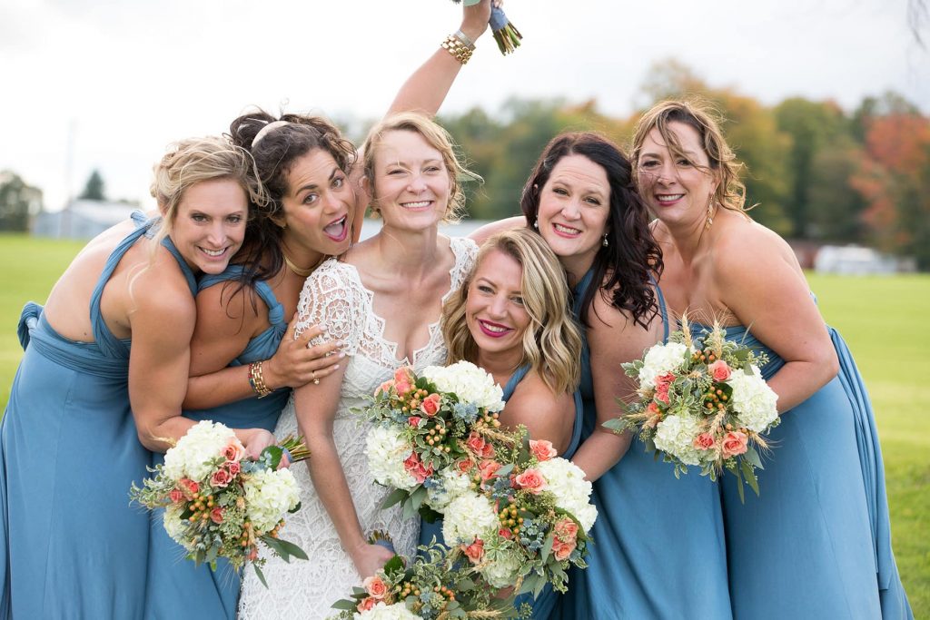 bridesmaids laugh and hug together