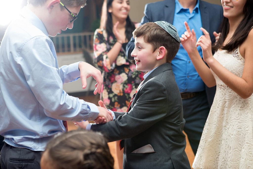the bar mitzvah boy and his brother dance