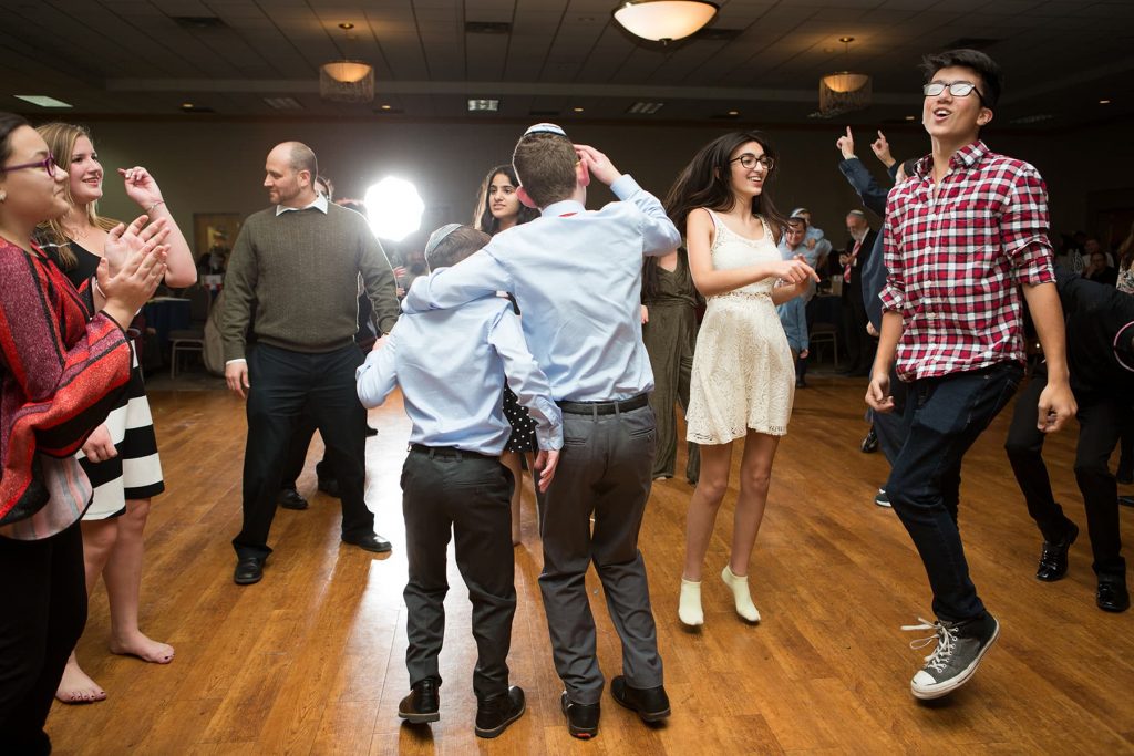 a newly bar mitzvah boy dances with his older brother