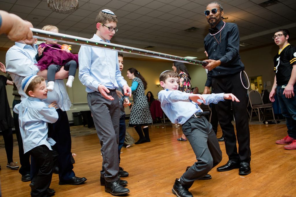 bar mitzvah boy doing the limbo with his siblings
