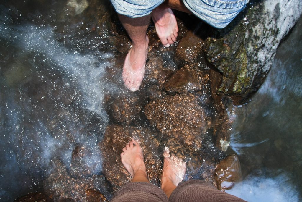 bare feet in a hot spring with sulfur water