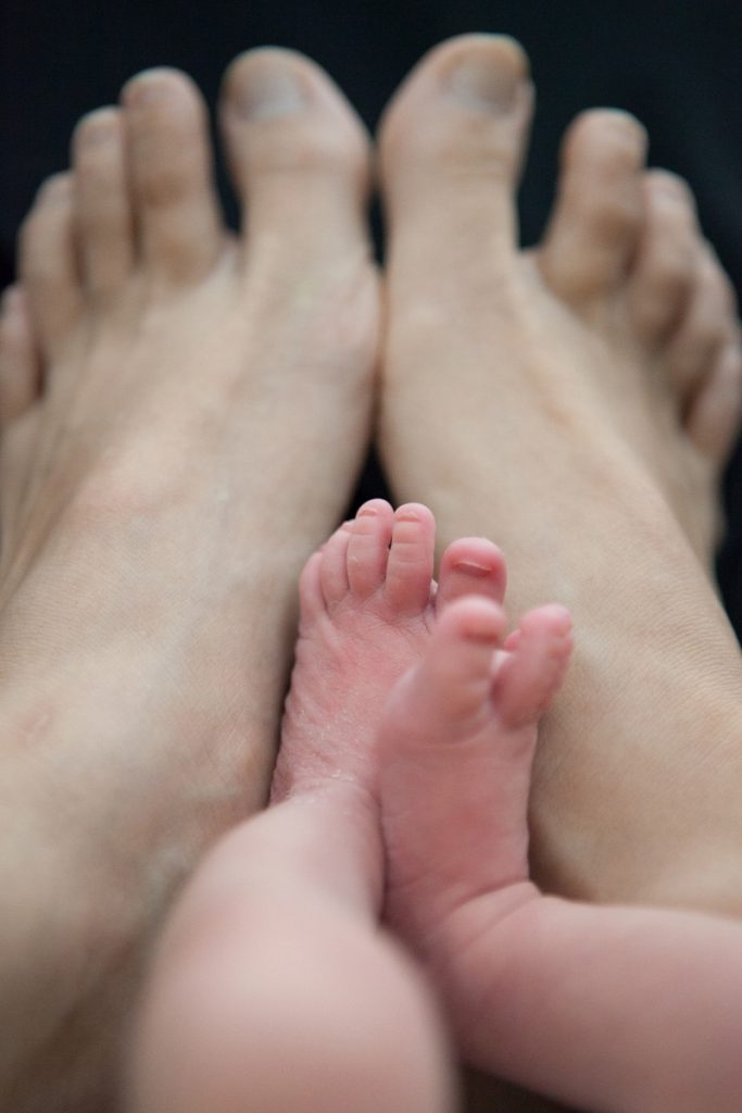 mama and newborn feet