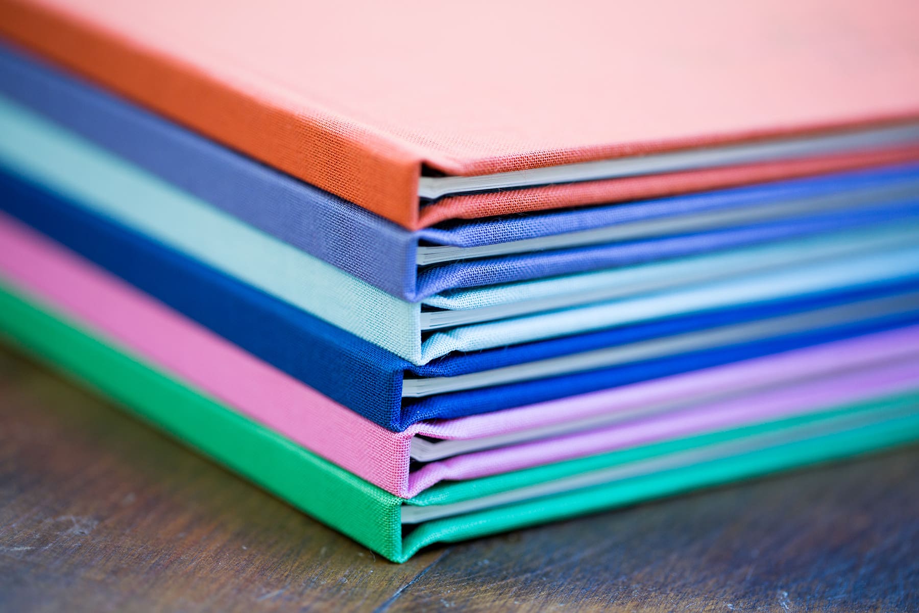 yearbooks with linen covers in a variety of colors