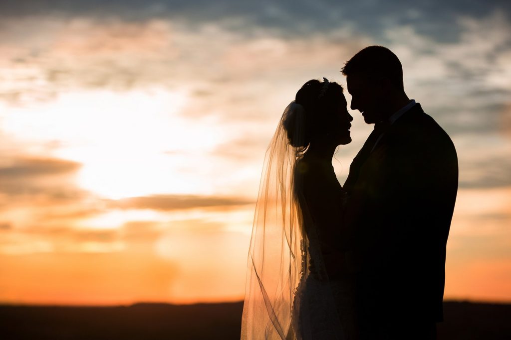 silhouette of a couple in front of a sunset