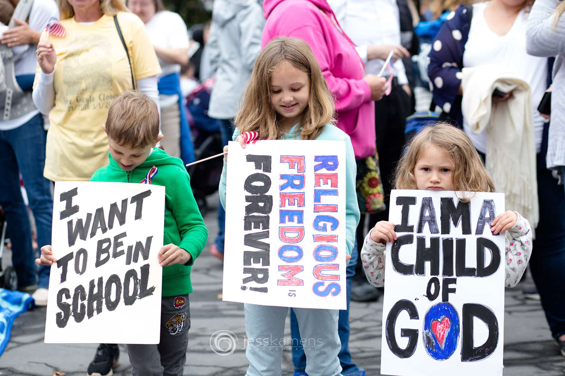 Children hold signs expression their wish for freedom and to be in school