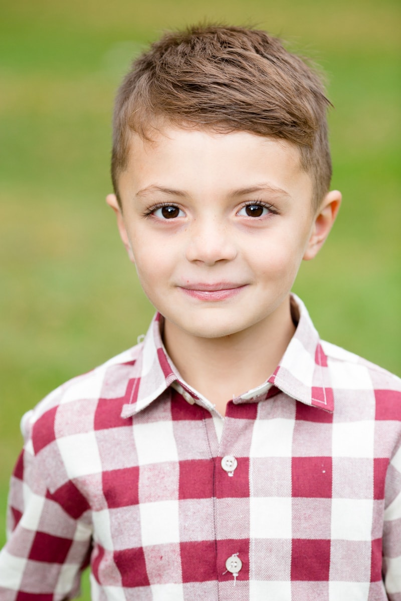 boy smiles for his school picture